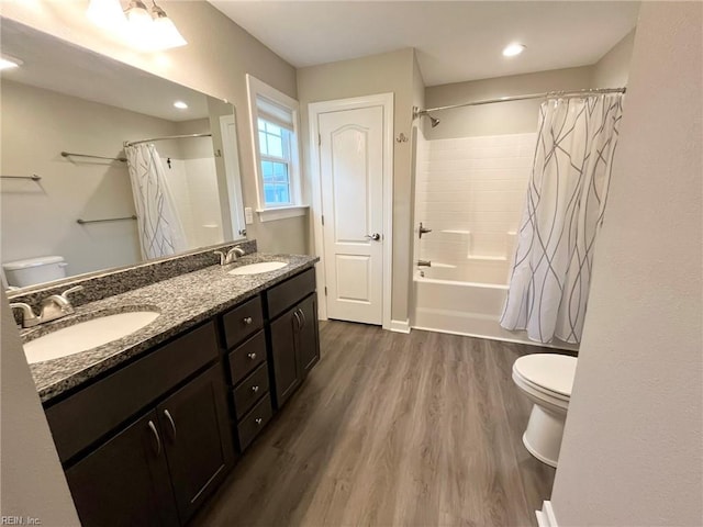 full bathroom featuring a sink, toilet, and wood finished floors