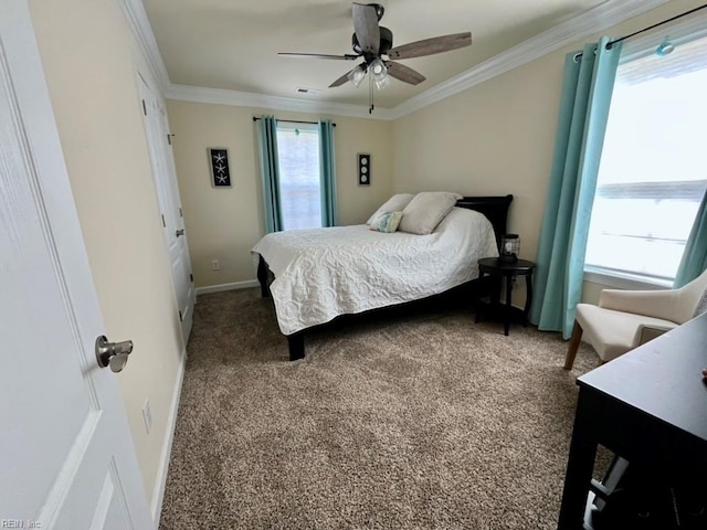 carpeted bedroom with crown molding, ceiling fan, baseboards, and visible vents