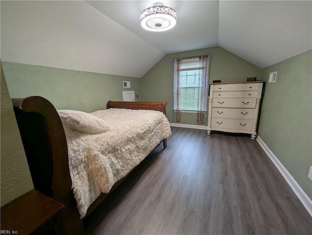 bedroom with dark wood-type flooring, baseboards, and vaulted ceiling