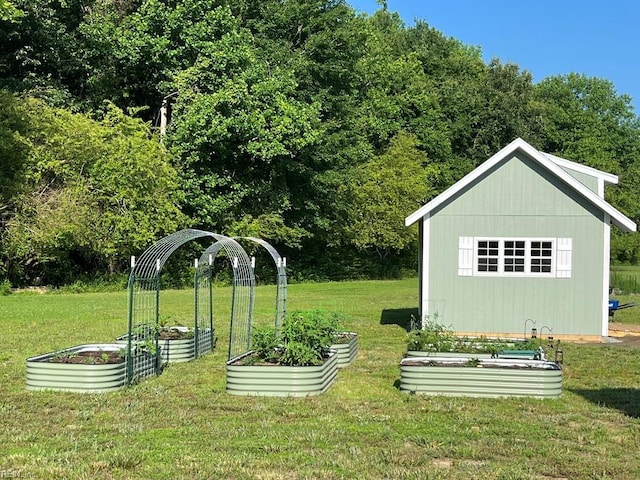 view of yard featuring a garden and an outbuilding