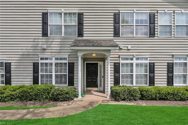doorway to property featuring a yard