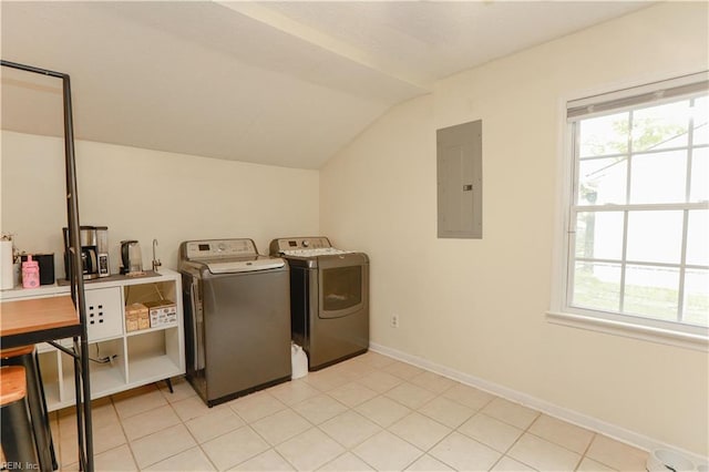 washroom featuring electric panel, washing machine and dryer, laundry area, and a healthy amount of sunlight