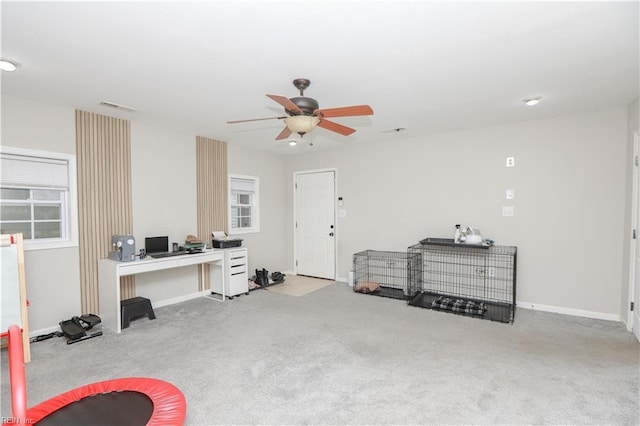 interior space with visible vents, ceiling fan, carpet, and baseboards