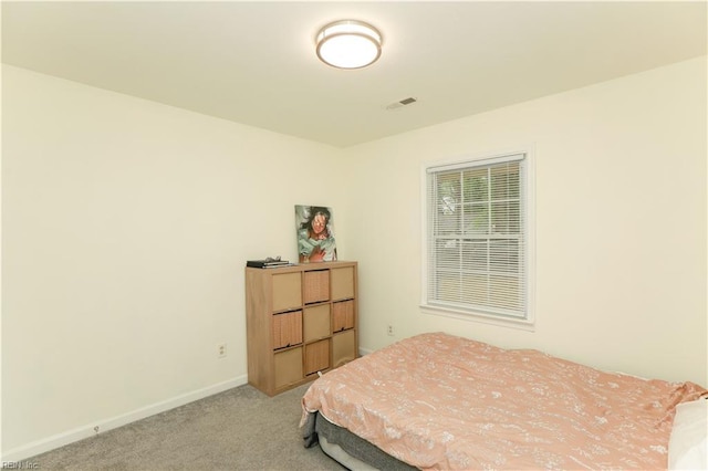 bedroom featuring light colored carpet, baseboards, and visible vents