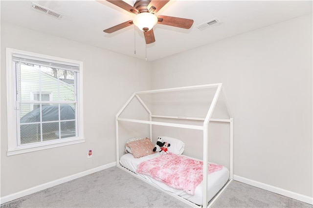 bedroom with carpet, visible vents, and baseboards
