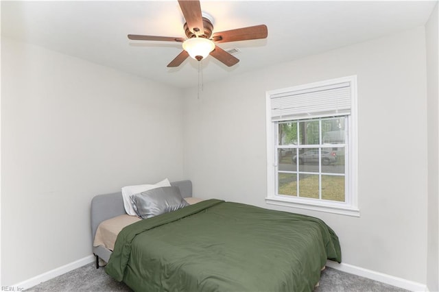 bedroom with ceiling fan, visible vents, baseboards, and carpet floors