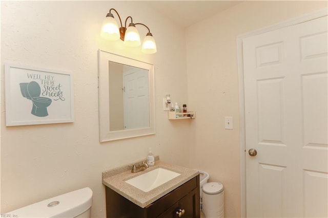 bathroom featuring toilet and vanity