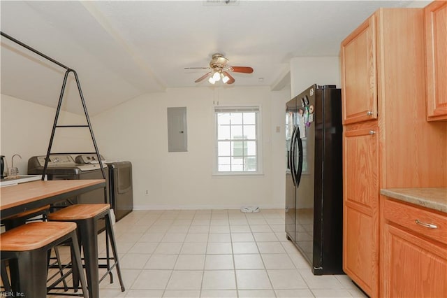 kitchen with ceiling fan, independent washer and dryer, electric panel, black fridge, and lofted ceiling