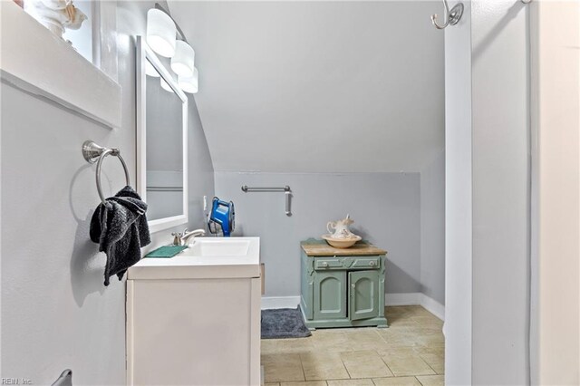 3410 E Princess Anne Rd, Norfolk, VA 23502 - bathroom with vanity, baseboards, and vaulted ceiling