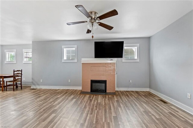 3410 E Princess Anne Rd, Norfolk, VA 23502 - unfurnished living room featuring ceiling fan, light wood-type flooring, a fireplace, and baseboards