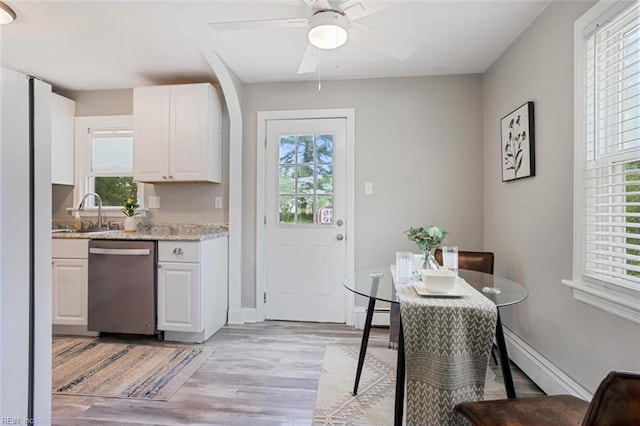 dining space featuring plenty of natural light, light wood finished floors, and a ceiling fan