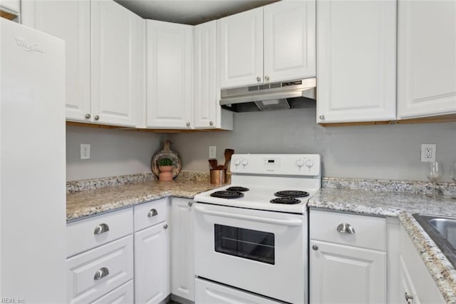 kitchen featuring under cabinet range hood, white appliances, and white cabinets