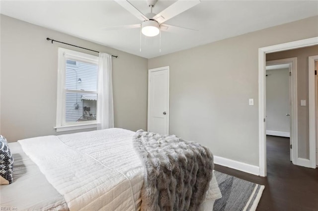 bedroom featuring a ceiling fan, baseboards, and dark wood finished floors