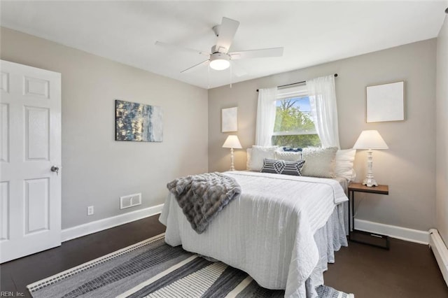 bedroom with baseboard heating, baseboards, a ceiling fan, and visible vents