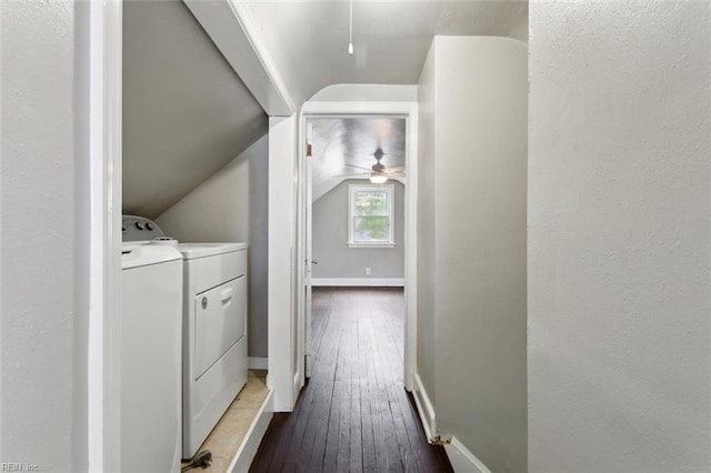 clothes washing area with baseboards, dark wood-style flooring, a ceiling fan, laundry area, and washing machine and clothes dryer