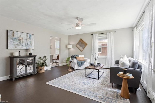 living room with ceiling fan, wood finished floors, and baseboards