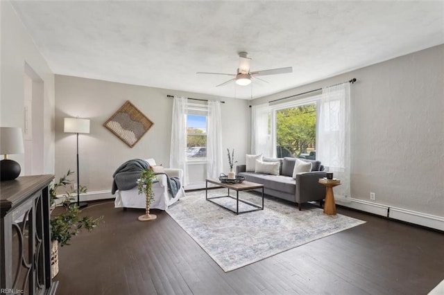 living area featuring wood-type flooring and a ceiling fan