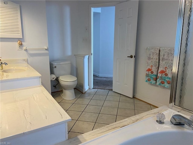 bathroom with toilet, tile patterned flooring, and vanity