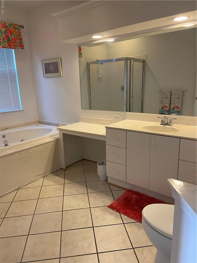 full bathroom featuring vanity, tile patterned flooring, toilet, a shower stall, and a garden tub