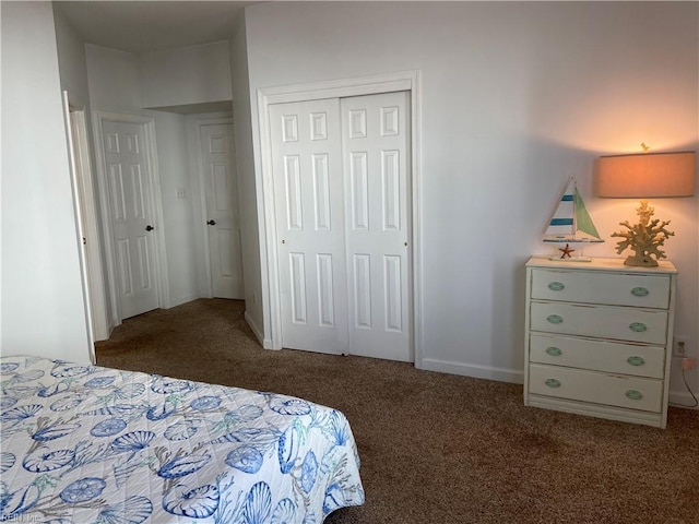 carpeted bedroom with a closet and baseboards