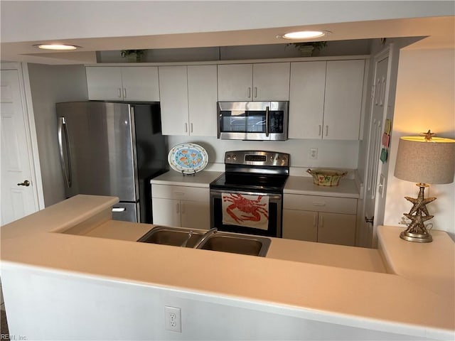 kitchen featuring a sink, light countertops, and stainless steel appliances
