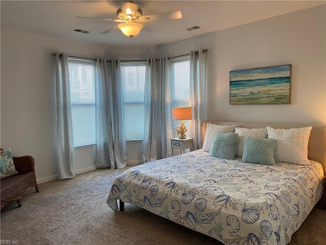 carpeted bedroom featuring visible vents, baseboards, and ceiling fan