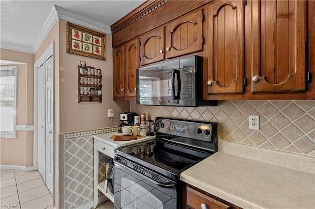 1206 Mabry Mill Pl, Chesapeake, VA 23320 - kitchen featuring crown molding, black appliances, light tile patterned flooring, light countertops, and brown cabinets