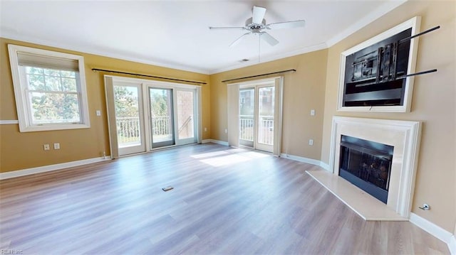 301 Brooke Ave Unit 105, Norfolk, VA 23510 - unfurnished living room featuring ornamental molding, a ceiling fan, a fireplace with raised hearth, wood finished floors, and baseboards