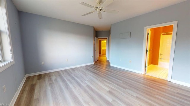 301 Brooke Ave Unit 105, Norfolk, VA 23510 - unfurnished bedroom featuring baseboards, light wood-type flooring, and ensuite bath