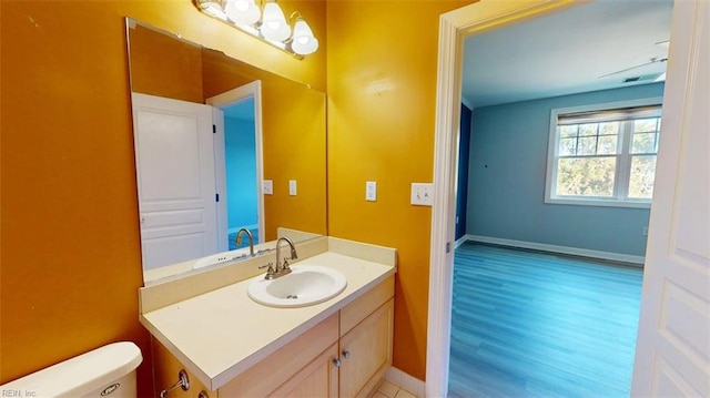 301 Brooke Ave Unit 105, Norfolk, VA 23510 - half bathroom featuring vanity, baseboards, toilet, visible vents, and wood finished floors