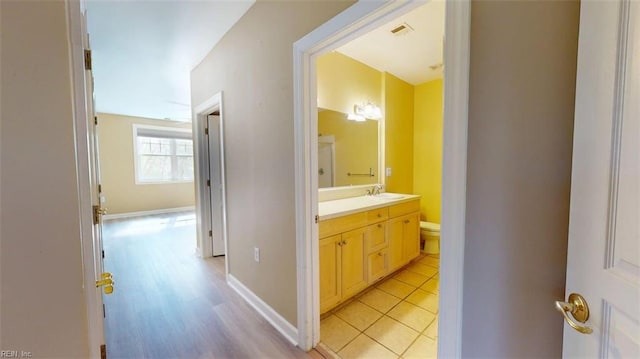 301 Brooke Ave Unit 105, Norfolk, VA 23510 - bathroom with tile patterned flooring, vanity, baseboards, and toilet