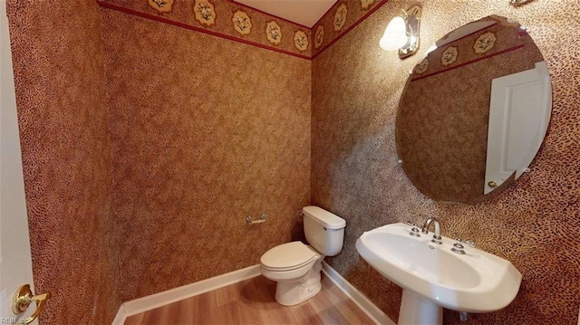 301 Brooke Ave Unit 105, Norfolk, VA 23510 - half bath with a sink, toilet, wood finished floors, and baseboards