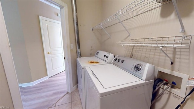 301 Brooke Ave Unit 105, Norfolk, VA 23510 - laundry room featuring washer and dryer, laundry area, light wood finished floors, and baseboards