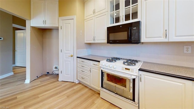 301 Brooke Ave Unit 105, Norfolk, VA 23510 - kitchen featuring white gas stove, black microwave, white cabinets, and light wood finished floors