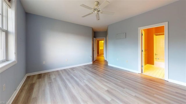 301 Brooke Ave Unit 105, Norfolk, VA 23510 - unfurnished bedroom featuring baseboards, light wood finished floors, and connected bathroom
