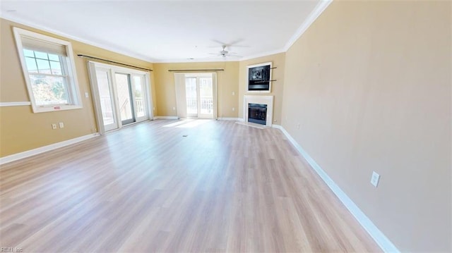 301 Brooke Ave Unit 105, Norfolk, VA 23510 - unfurnished living room with baseboards, ceiling fan, light wood-style floors, crown molding, and a fireplace with flush hearth