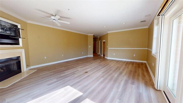 301 Brooke Ave Unit 105, Norfolk, VA 23510 - unfurnished living room with ceiling fan, light wood-style flooring, ornamental molding, a fireplace with raised hearth, and baseboards