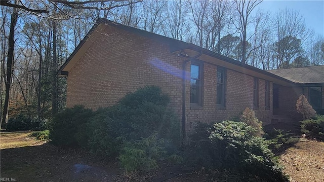 view of side of property featuring brick siding