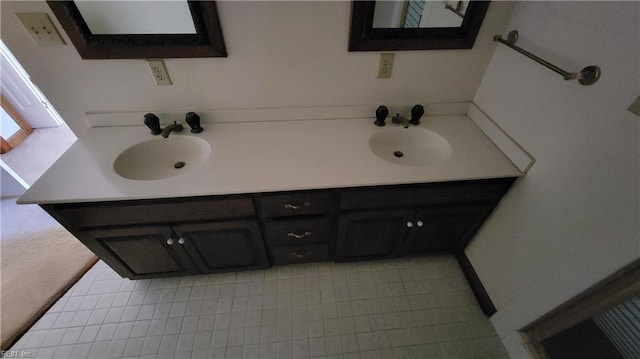 full bathroom with a sink and double vanity