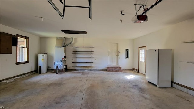 garage with a garage door opener, freestanding refrigerator, and electric water heater