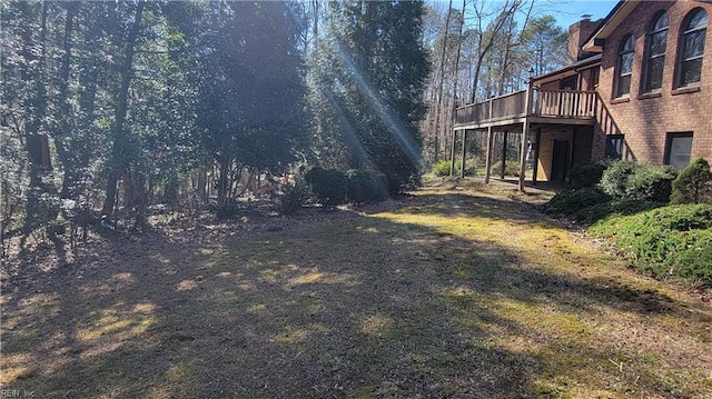 view of yard with a deck and stairway