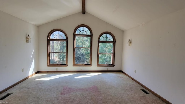 carpeted empty room featuring visible vents, baseboards, and vaulted ceiling with beams