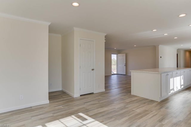 unfurnished room with ornamental molding, baseboards, recessed lighting, and light wood-style floors
