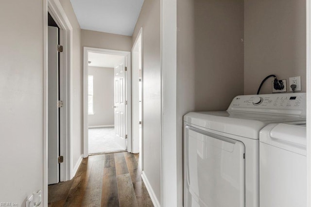 laundry area featuring laundry area, baseboards, dark wood finished floors, and washing machine and dryer