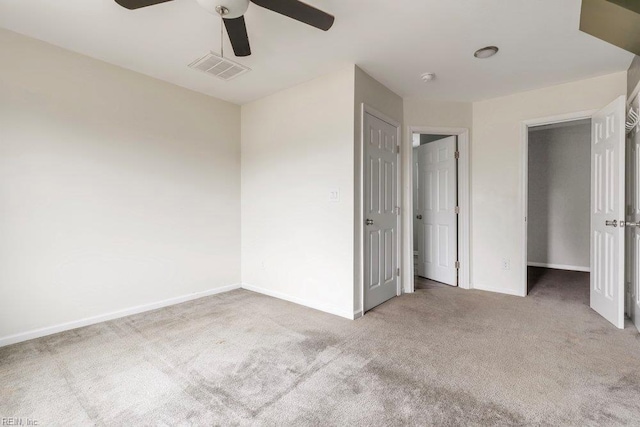 unfurnished bedroom with carpet, visible vents, baseboards, and ceiling fan