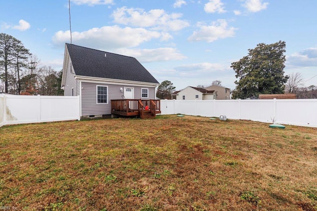 back of property with a wooden deck, crawl space, a yard, a fenced backyard, and a shingled roof