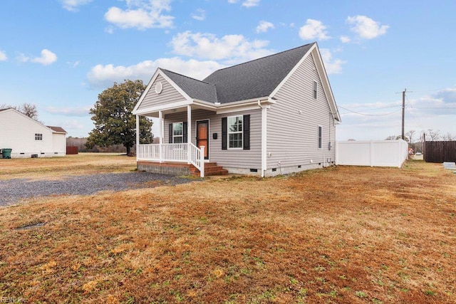 bungalow with crawl space, covered porch, a front yard, and fence