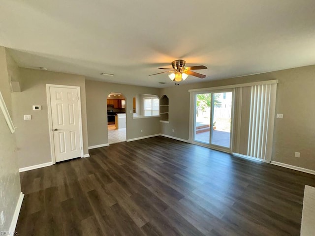 3216 Winterberry Ct, Virginia Beach, VA 23453 - unfurnished living room with arched walkways, dark wood finished floors, baseboards, and a ceiling fan