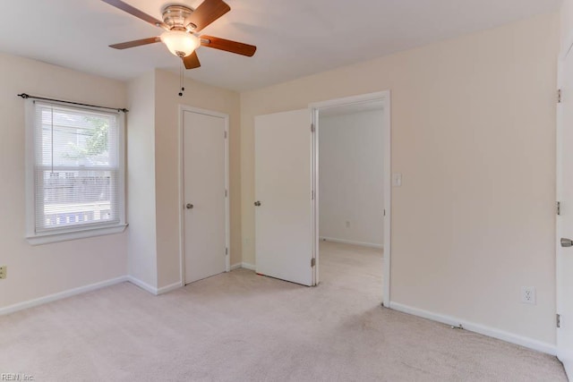 unfurnished bedroom with carpet, baseboards, and a ceiling fan