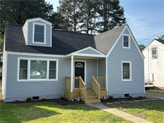 cape cod house featuring a front lawn, roof with shingles, and crawl space
